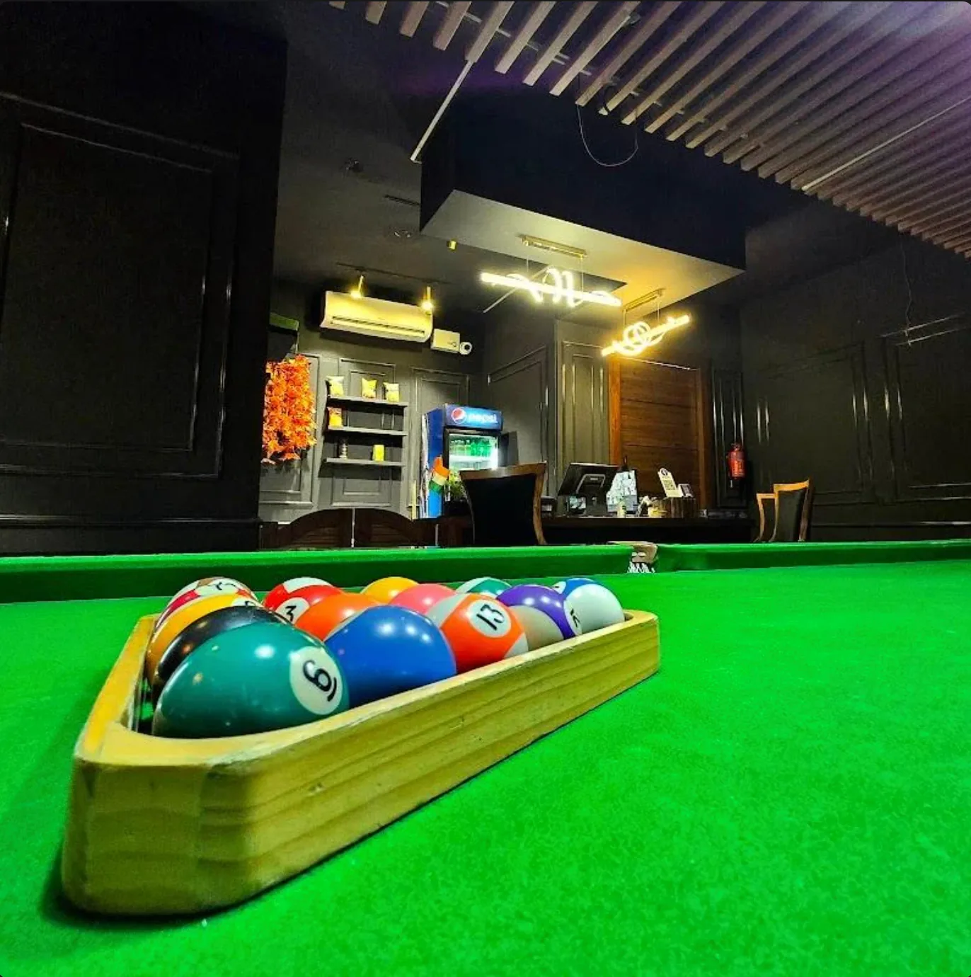 Racked pool balls on the green baize